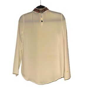 Long sleeve top with multi color beaded neck.